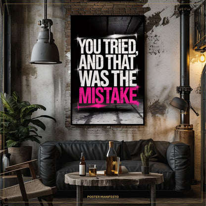 Living room with a black sofa, coffee table, and 'You Tried, and That Was the Mistake' poster.