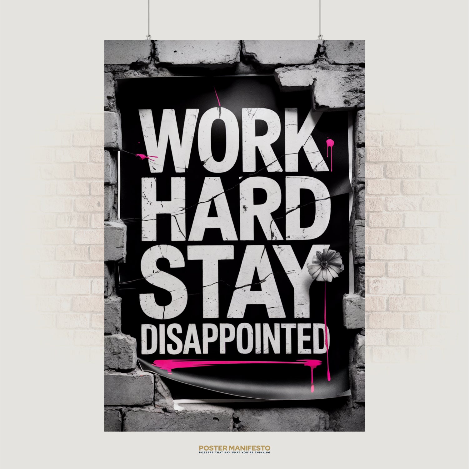 Bold typography poster reading “Work Hard Stay Disappointed” with pink paint splashes and brick frame