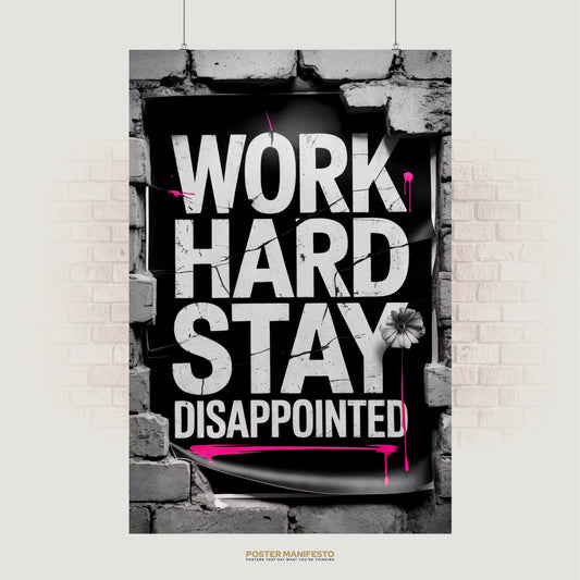 Bold typography poster reading “Work Hard Stay Disappointed” with pink paint splashes and brick frame