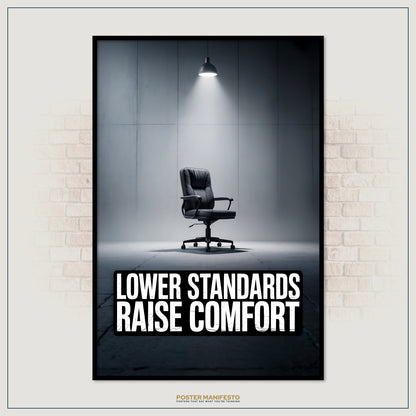 Poster with a black office chair in a dimly lit room and text 'LOWER STANDARDS RAISE COMFORT' on a brick wall background.