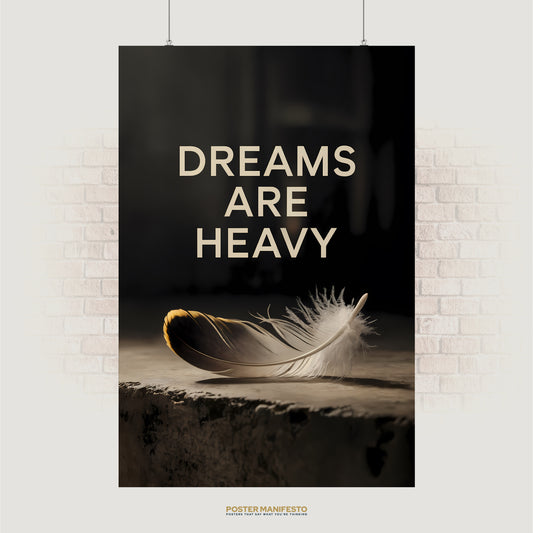 Minimalist poster reading “Dreams Are Heavy” with feather on stone surface in soft lighting