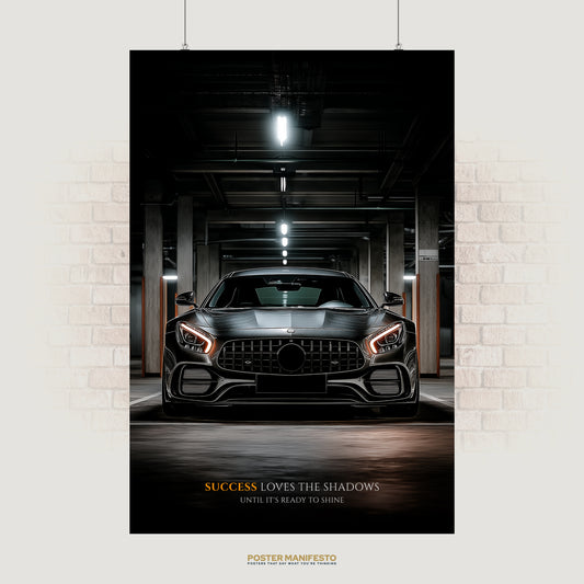 Motivational poster with a black luxury sports car in a dim garage, paired with the quote “Success Loves the Shadows Until It’s Ready to Shine.”