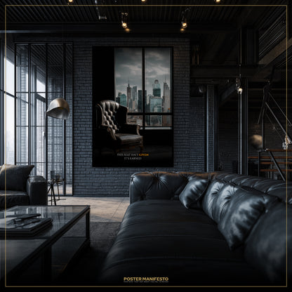 Modern living room with a large black leather sofa, glass coffee table, and a framed poster on the wall.