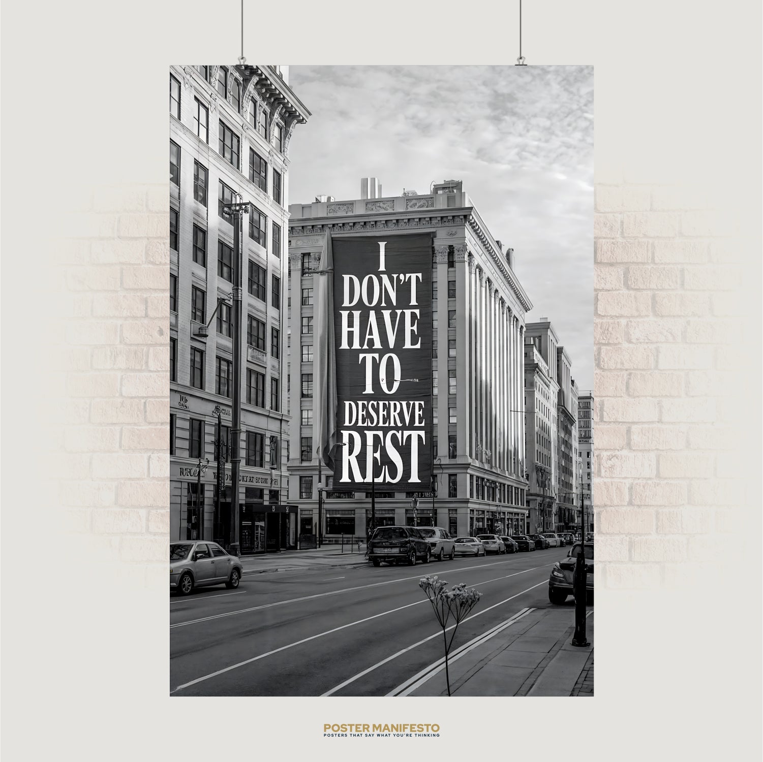 Black and white cityscape with billboard reading “I Don’t Have To Deserve Rest”