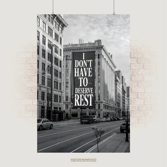 Black and white cityscape with billboard reading “I Don’t Have To Deserve Rest”