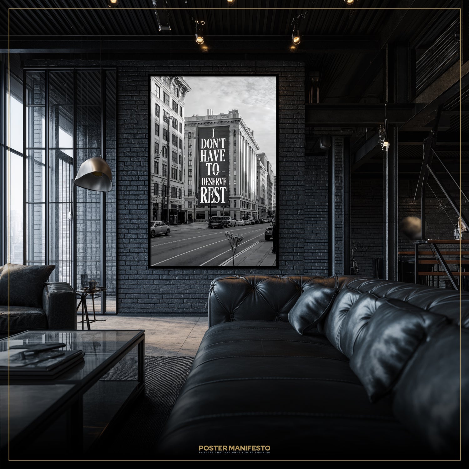 Modern living room with a black leather sofa and a framed poster on the wall.