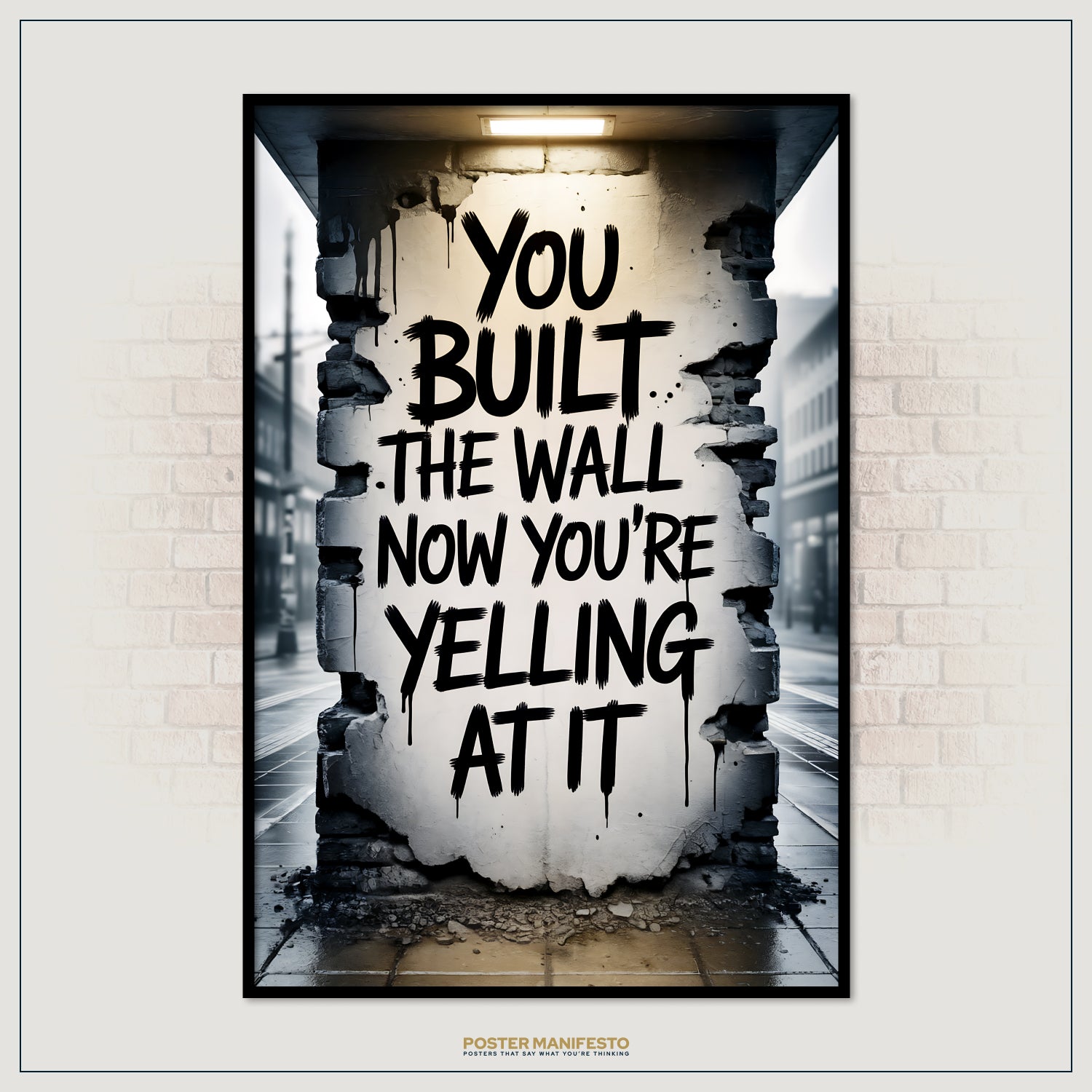Poster with text 'You built the wall, now you're yelling at it' on a wall with a broken section.
