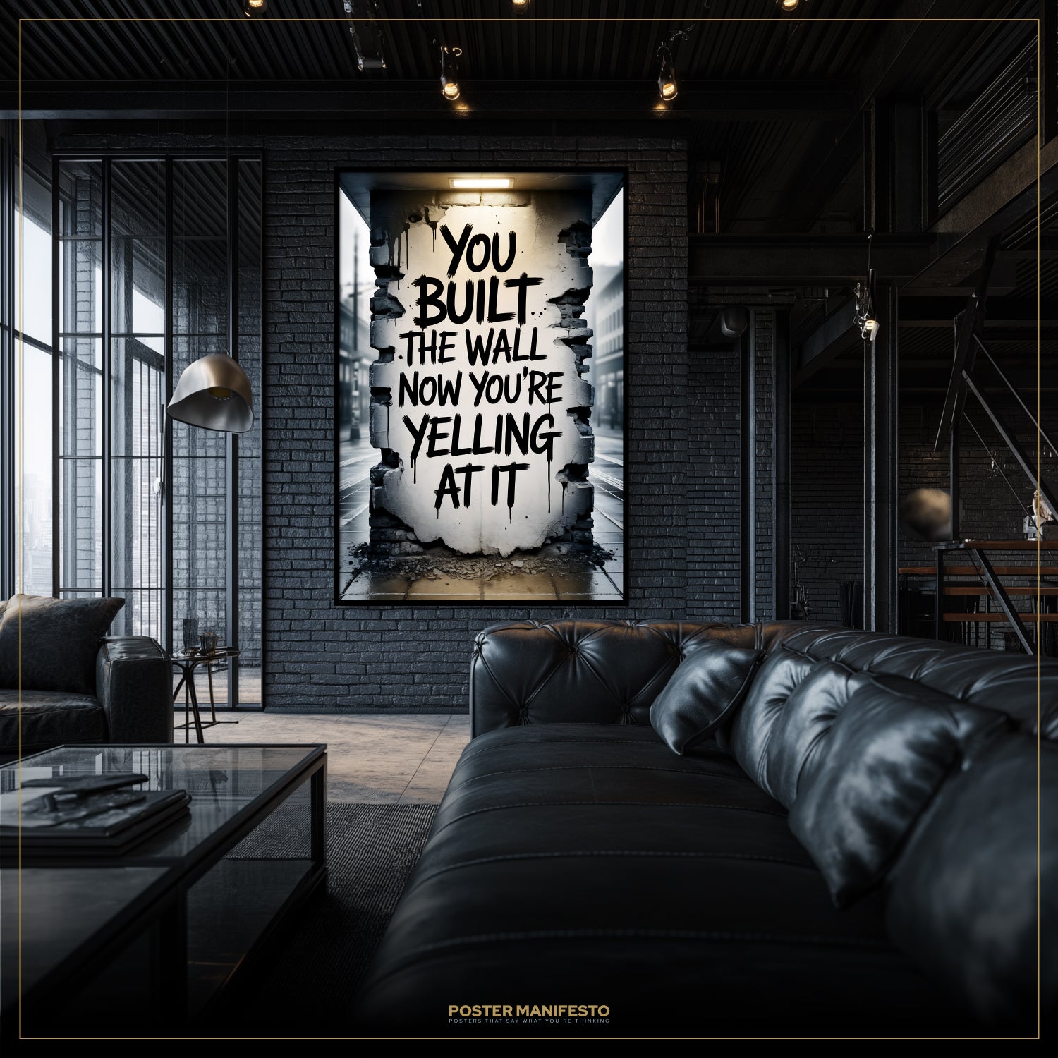 Modern living room with a black leather sofa and a framed poster on the wall.
