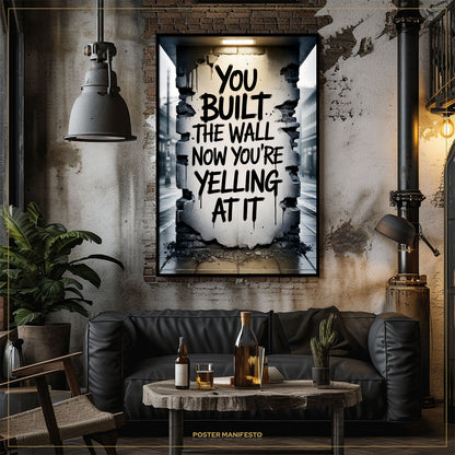 Living room with a black leather sofa, wooden coffee table, and framed poster on the wall.