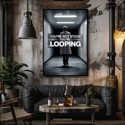 Living room with a dark-themed poster on the wall, featuring a man walking down a hallway with text 'You're not stuck, you're looping'.