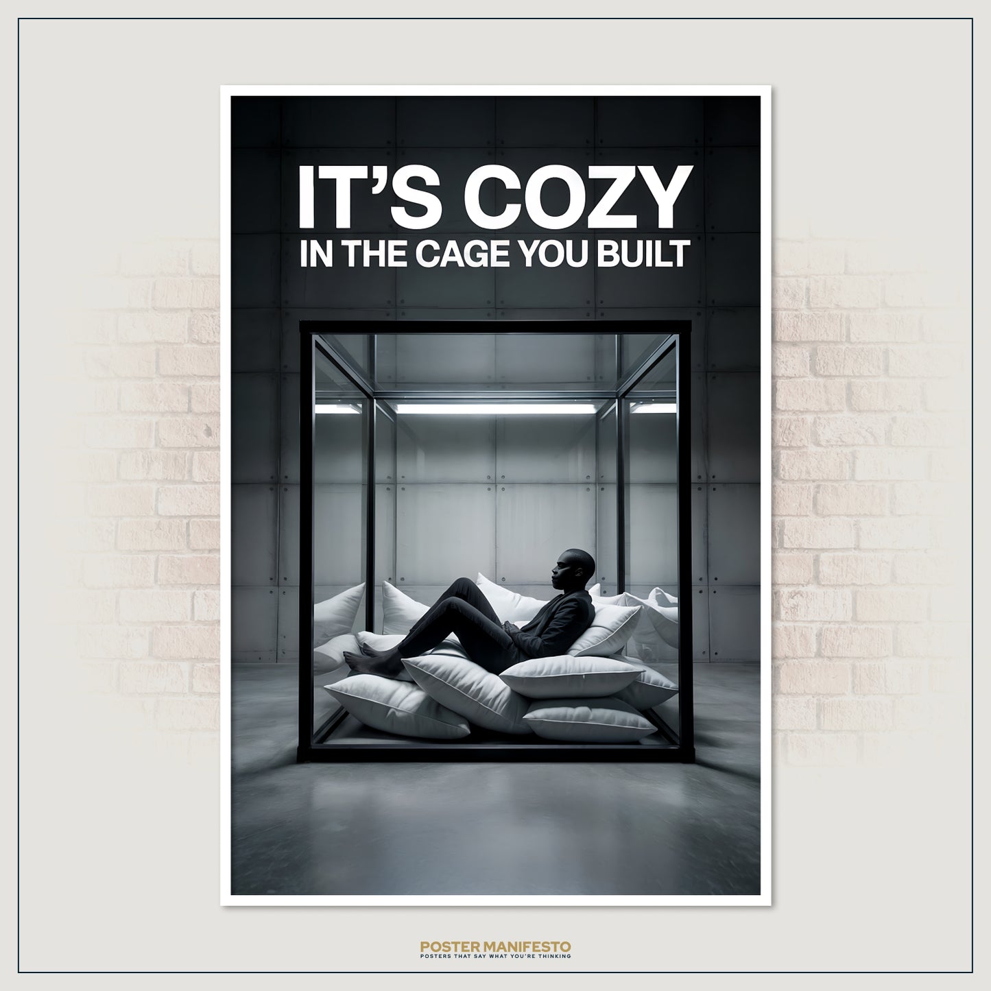 Clean, high-contrast poster depicting a man inside a glass box, surrounded by soft pillows, under the impactful statement “It’s Cozy In The Cage You Built.”