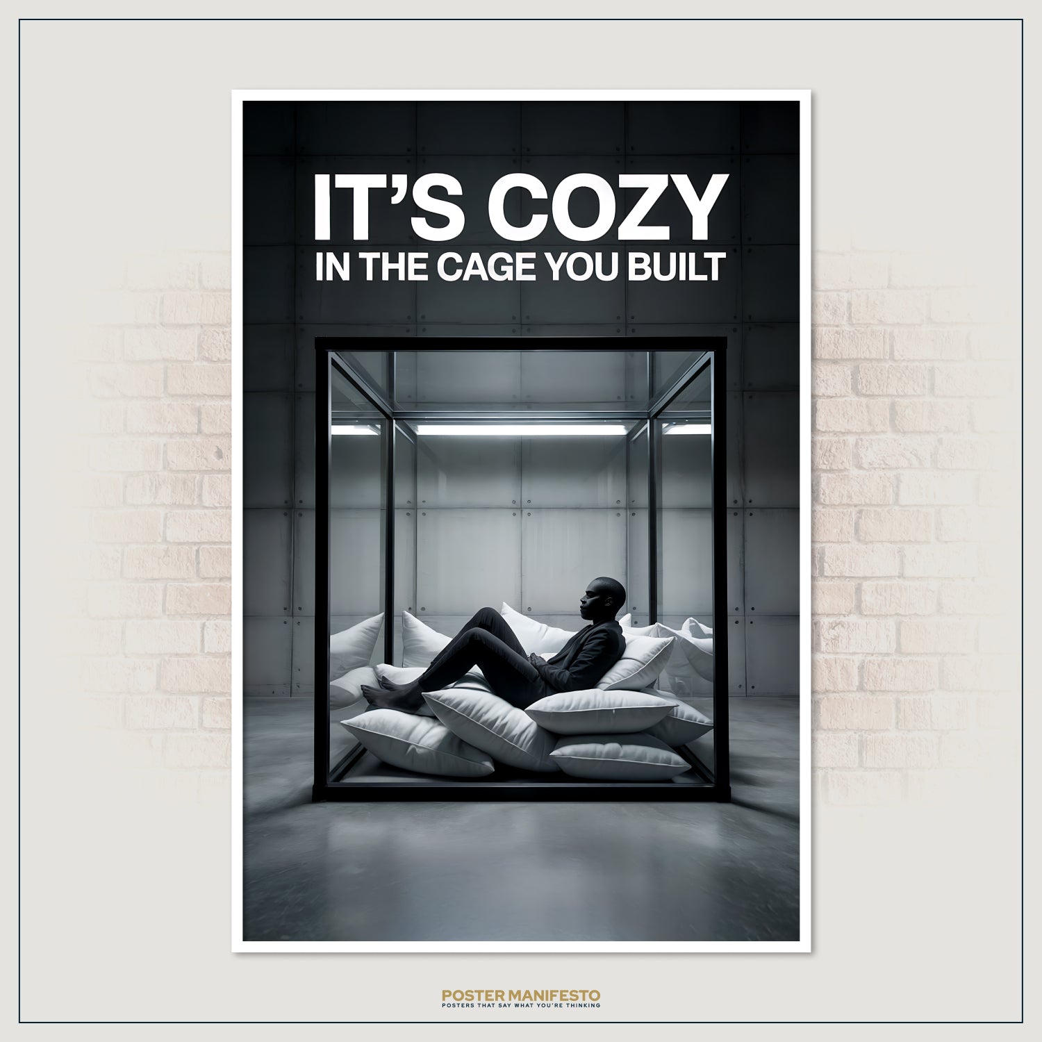 Clean, high-contrast poster depicting a man inside a glass box, surrounded by soft pillows, under the impactful statement “It’s Cozy In The Cage You Built.”