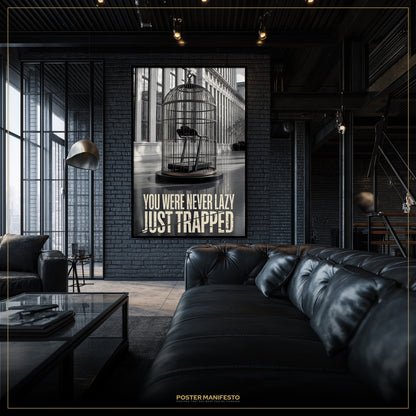 Modern living room with a black leather sofa and a framed poster on the wall.