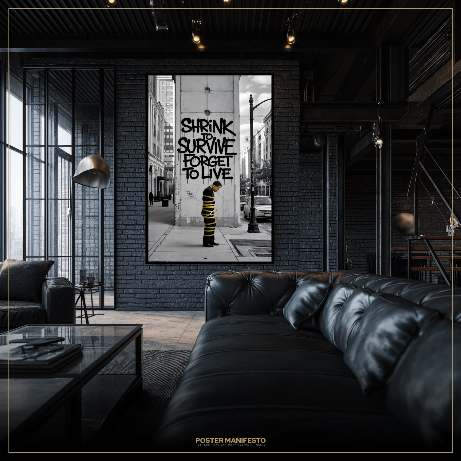 Modern living room with a black leather sofa and a framed poster on the wall.