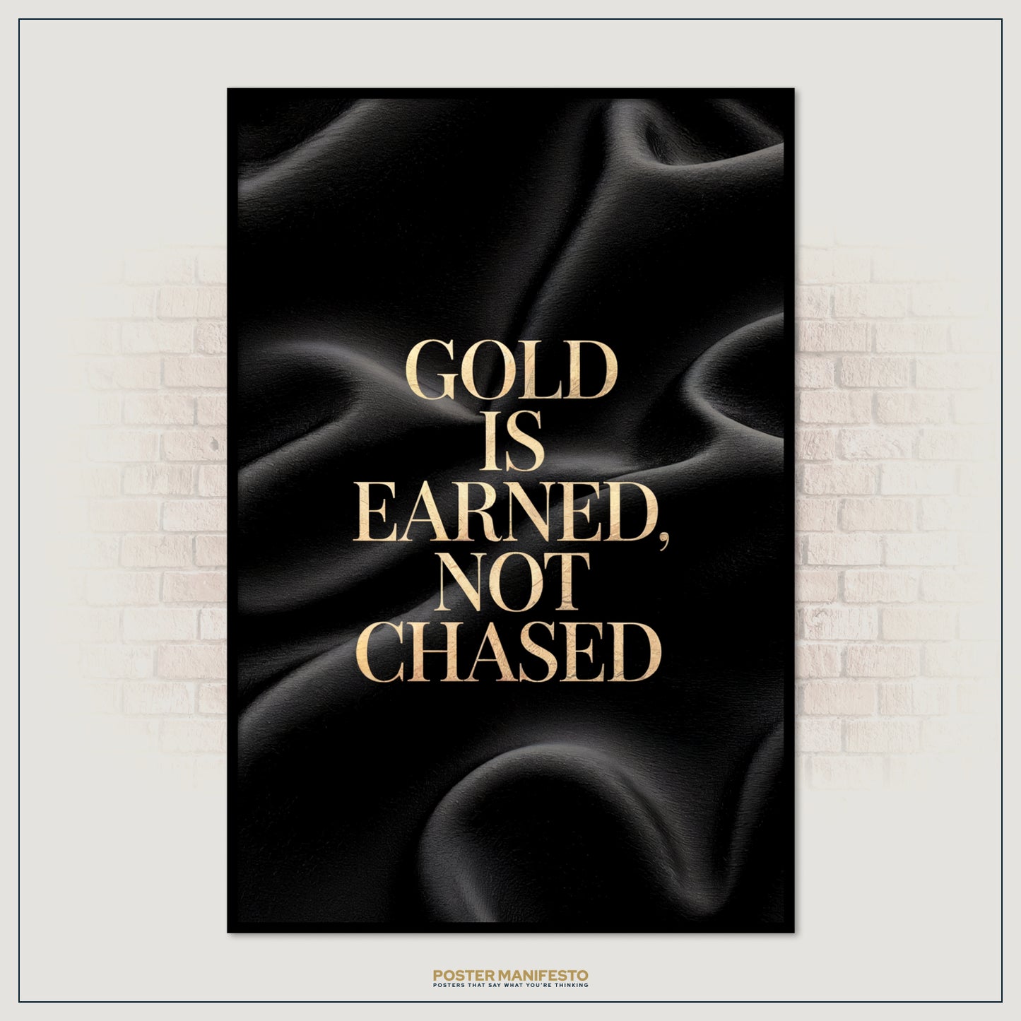 Poster with gold text 'Gold is earned, not chased' on a black background, framed against a brick wall.