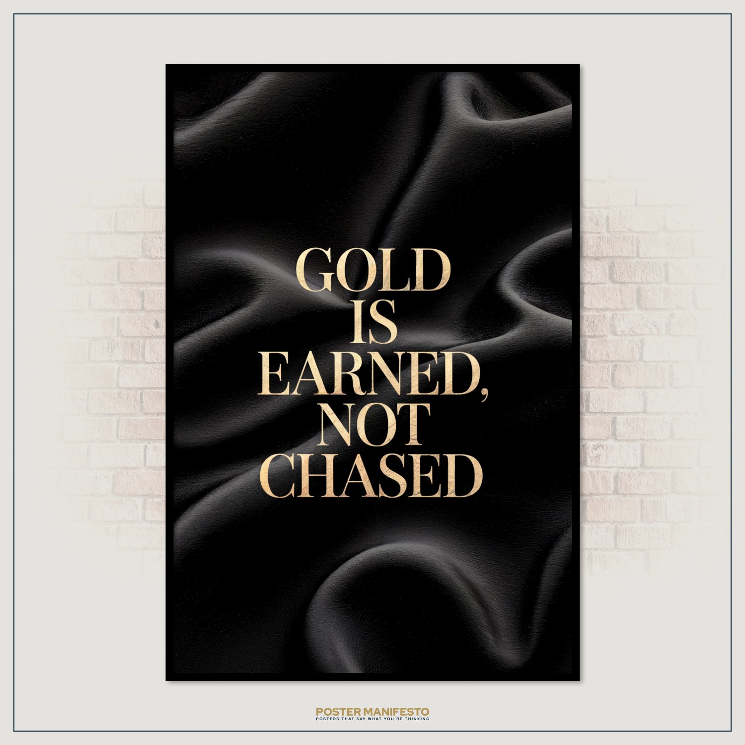 Poster with gold text 'Gold is earned, not chased' on a black background, framed against a brick wall.