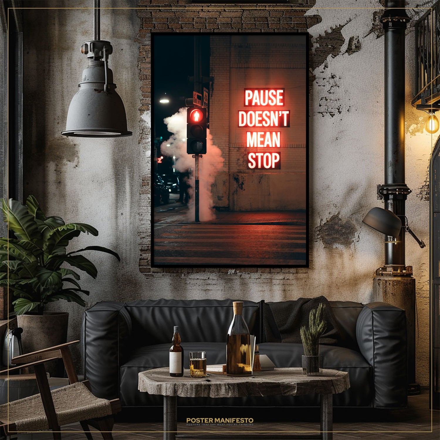 Living room with a 'Pause Doesn't Mean Stop' poster on the wall, a black sofa, and a table with drinks.