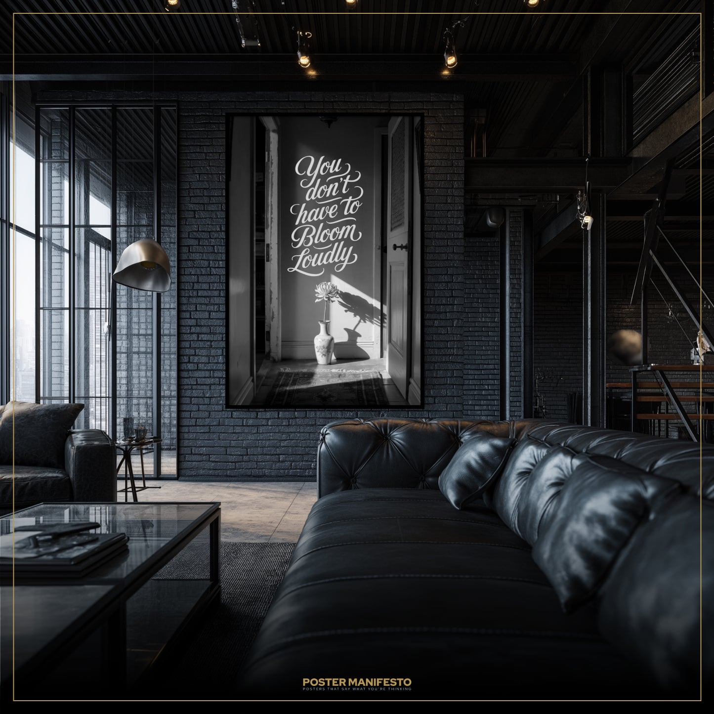 Modern living room with a black leather sofa and a framed quote on the wall.
