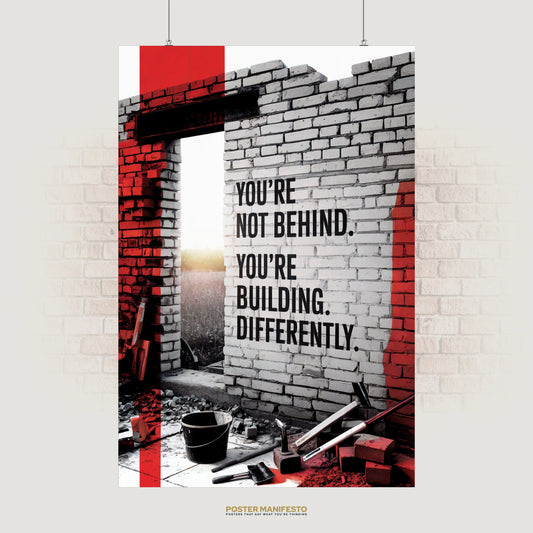 Motivational poster with the quote “You’re Not Behind. You’re Building Differently” on a brick wall.