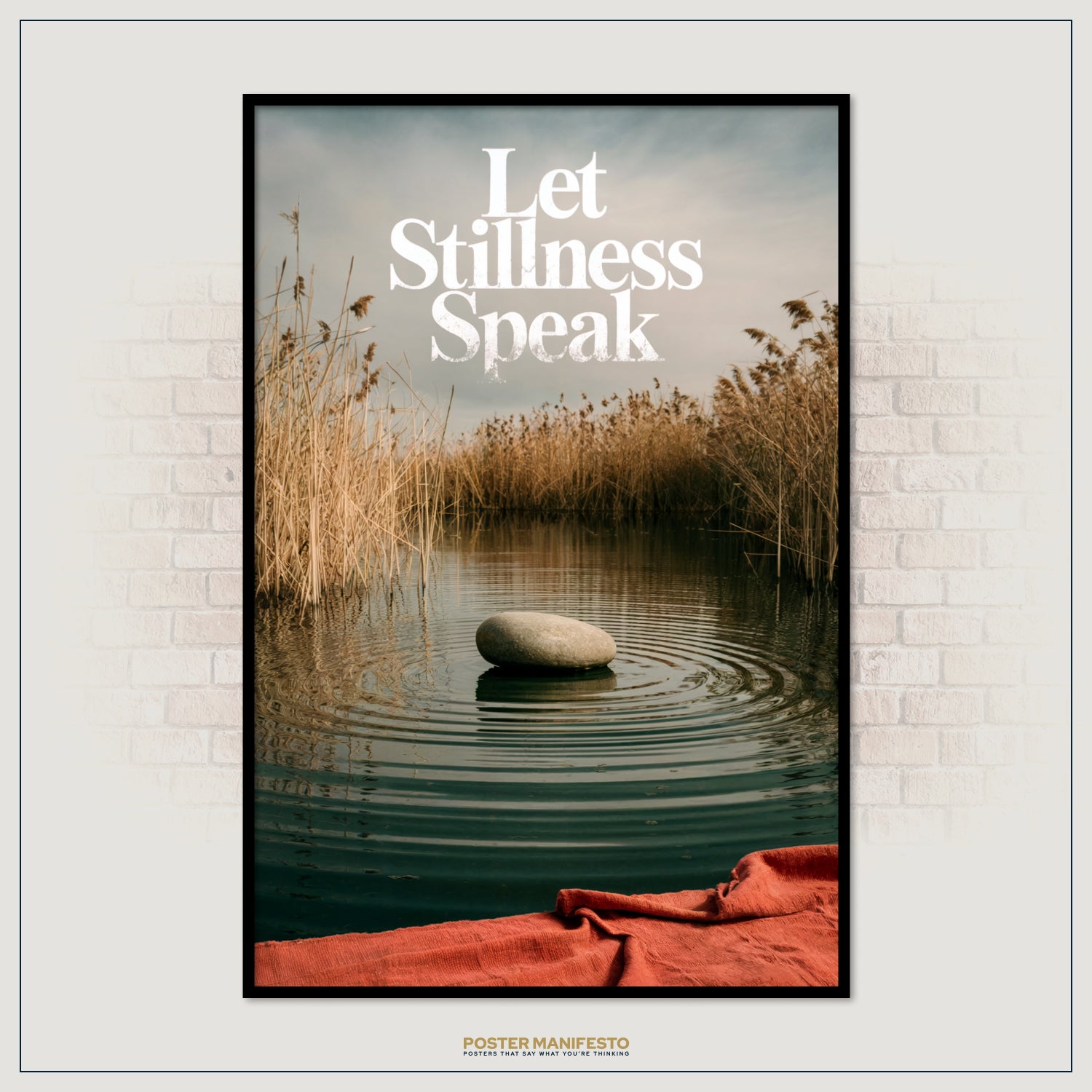 Poster with a stone in water and 'Let Stillness Speak' text, framed on a wall.