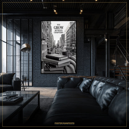 Modern interior with a black leather sofa and a framed poster on a brick wall.