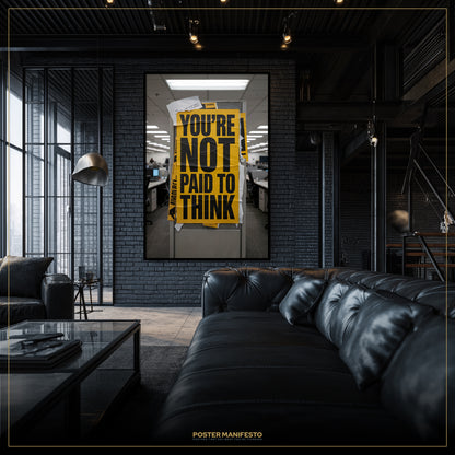 Modern interior with a black leather sofa and a framed poster on the wall.