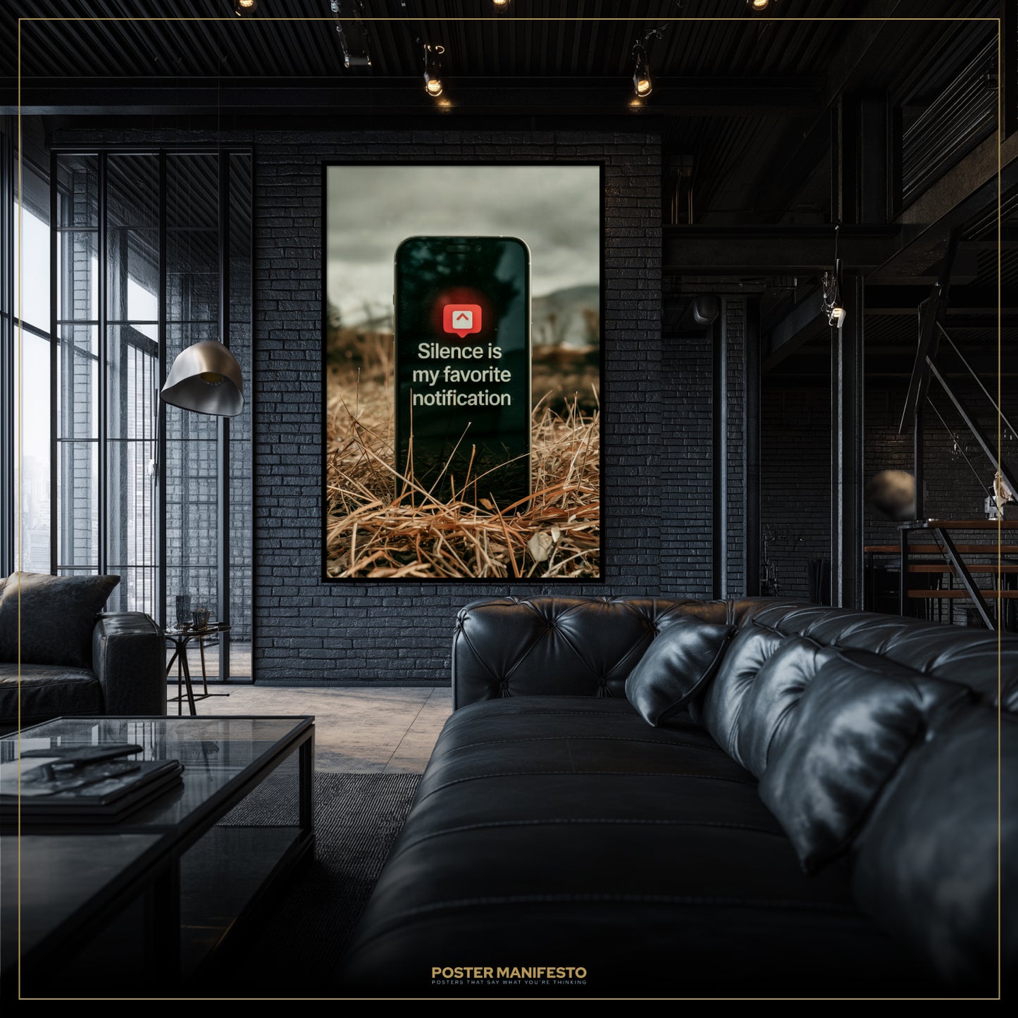 Modern living room with a black leather sofa and a framed poster on the wall.