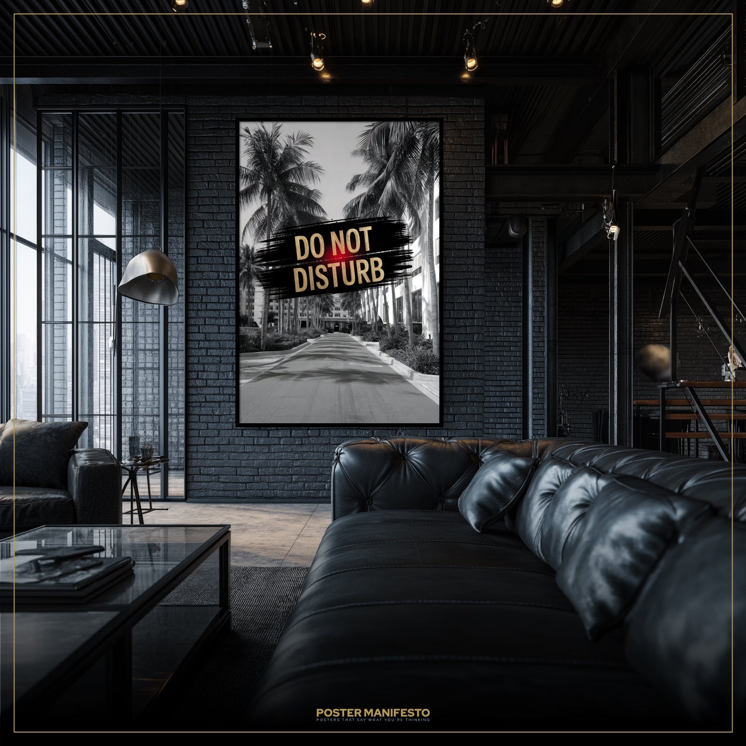 Modern living room with a black leather sofa and a framed poster on the wall.
