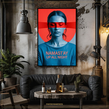 Living room with a framed poster of a woman with red and blue design, text 'Namast'ay Up All Night', and a black sofa.